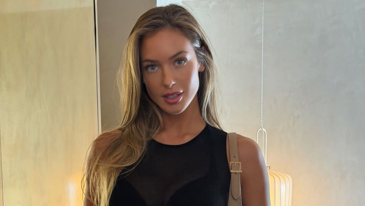 Hannah Palmer showcases the perfect blend of minimalist elegance and modern chic in a timeless sleeveless black top that effortlessly elevates everyday fashion.