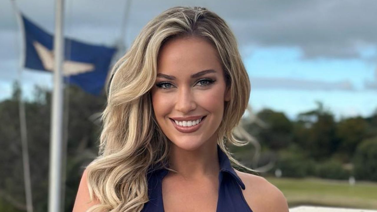Paige Spiranac embodies timeless athletic elegance in a classic navy collared top, proving that refined activewear can easily transition from the golf course to everyday style.