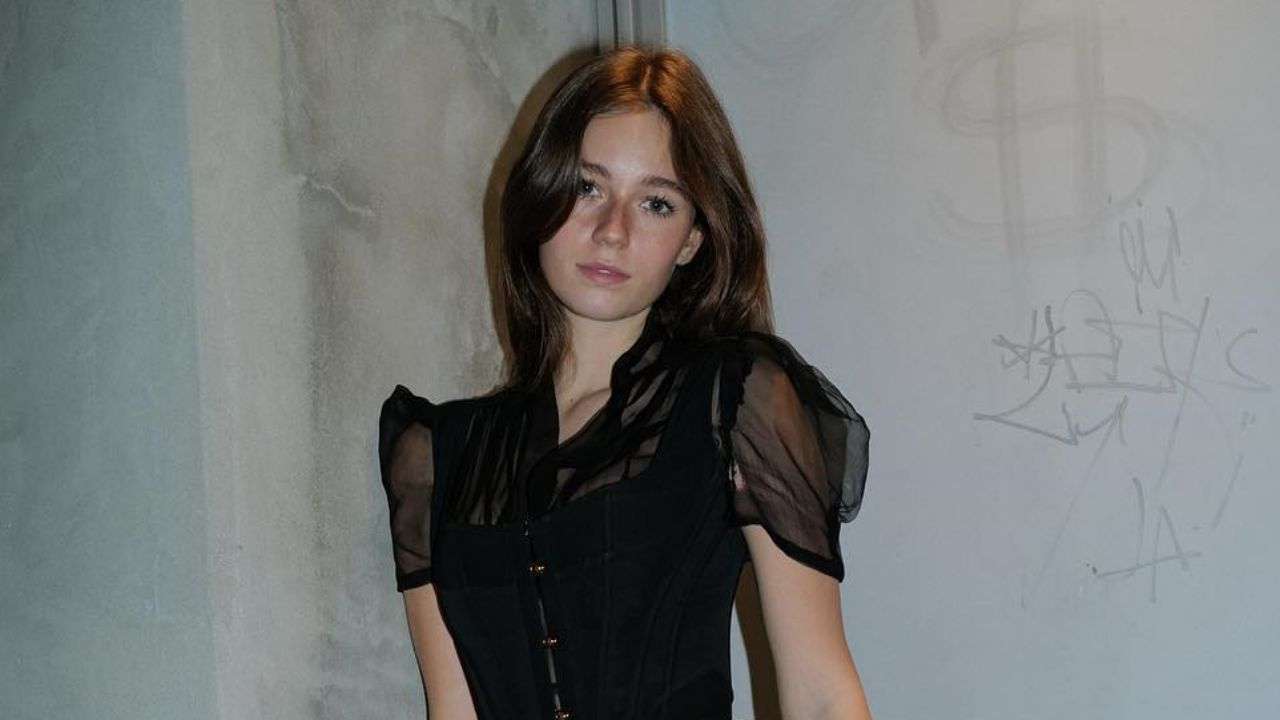 Anna Malygon showcases a chic gothic romance aesthetic in a structured black corset top accented with delicate sheer puff sleeves.