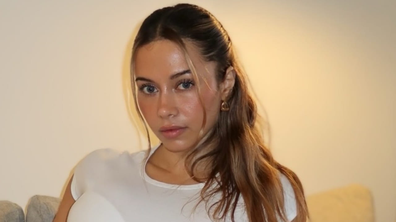 Bell Malk pairs a classic white crewneck staple with soft, radiant makeup to showcase the ultimate understated everyday glam.