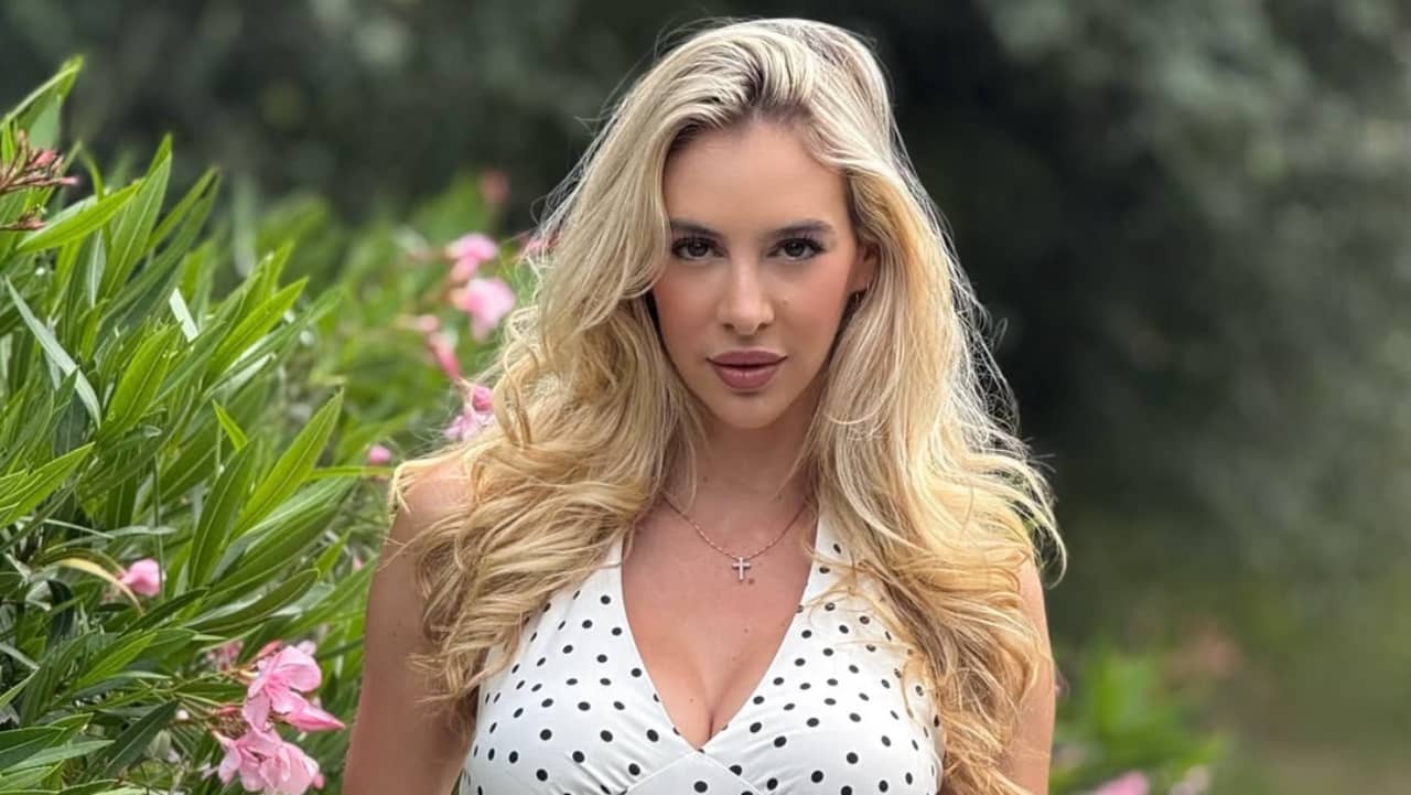 Bri Teresi captures breezy summer elegance in a classic polka-dot halter dress accented with delicate jewelry and soft, voluminous waves.