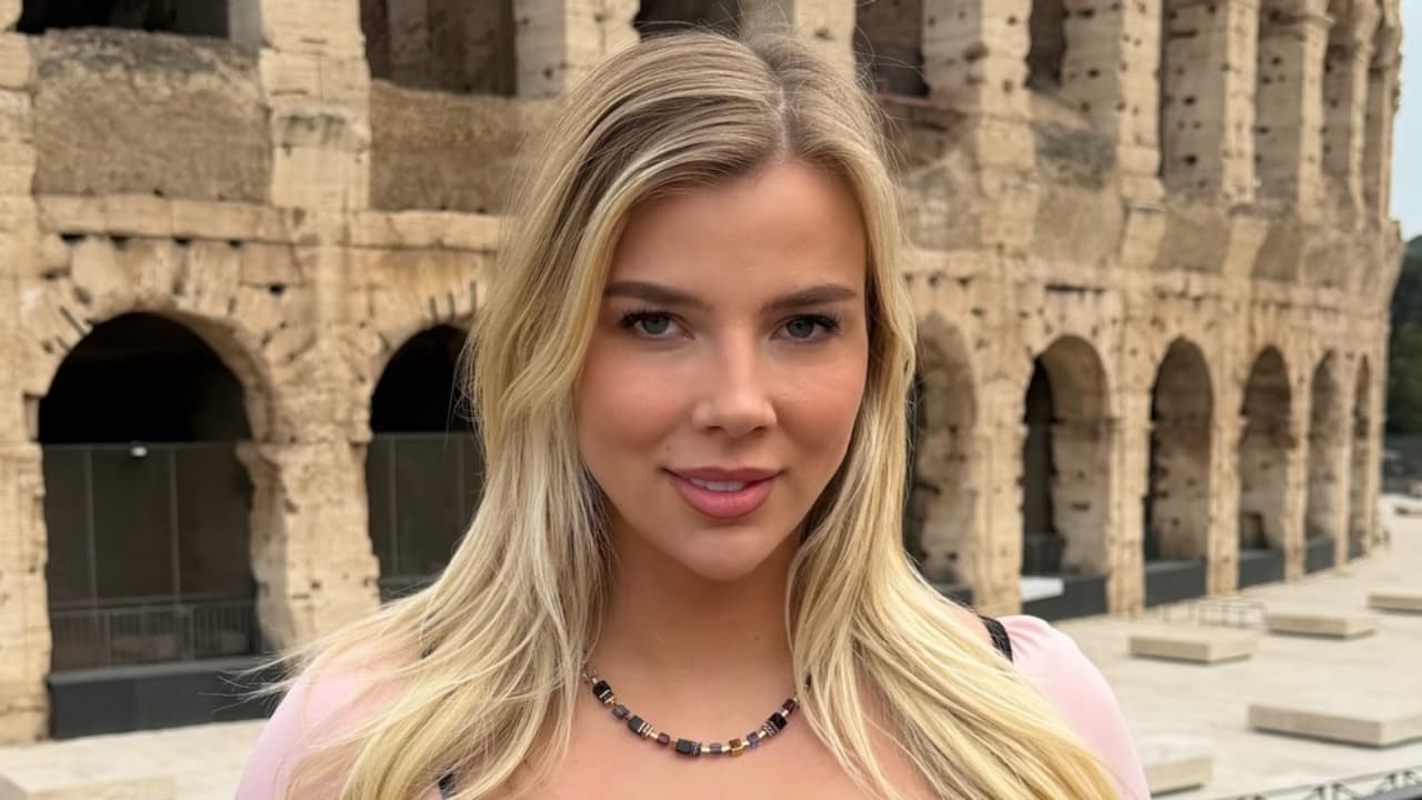 Luxy Dutch embraces effortless European vacation style in Rome, accenting a soft pastel top with a vibrant geometric beaded statement necklace.