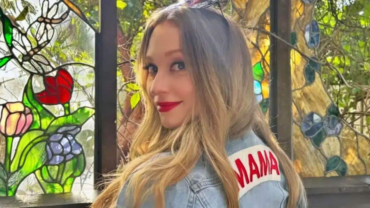 Effortlessly bridging casual cool with personal sentiment, Natalie Viscuso makes a confident statement in a personalized denim jacket and a matching red lip.