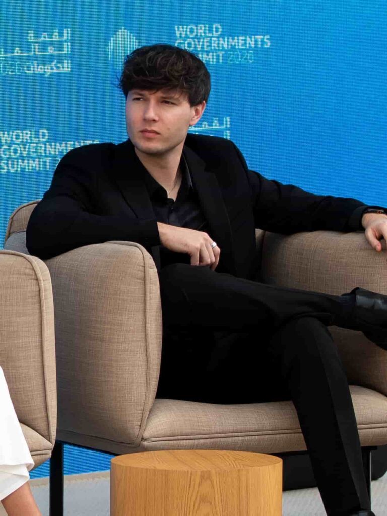 Zach Justice delivers sleek contemporary sophistication in a sharply tailored all-black monochromatic suit complemented by polished dress shoes and subtle silver jewelry.