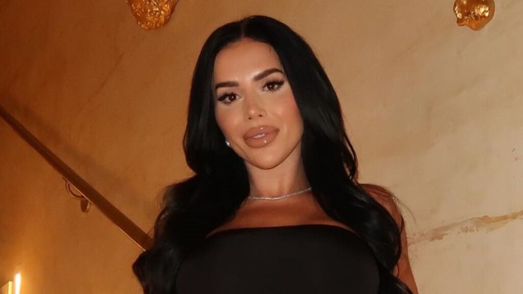 Desiree Dee delivers timeless evening elegance by pairing a sleek strapless black silhouette with a delicate diamond tennis necklace for an understated luxury look.