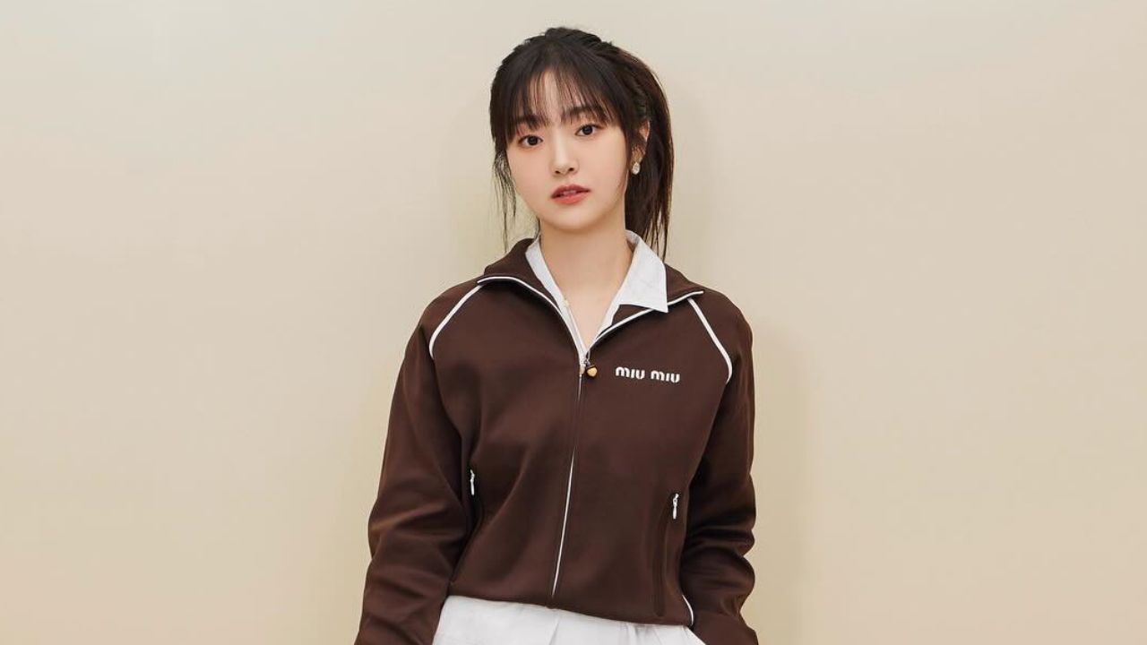 Kim Hye Jun exemplifies sophisticated athleisure style by pairing an iconic Miu Miu track jacket with a crisp white collared top and matching bottoms.