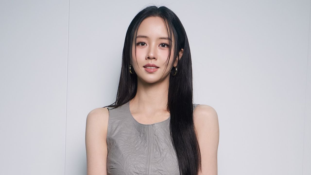 Kim So Hyun captures contemporary quiet luxury in a textured slate-gray sleeveless dress accented with minimalist gold hoop earrings and sleek, center-parted tresses.