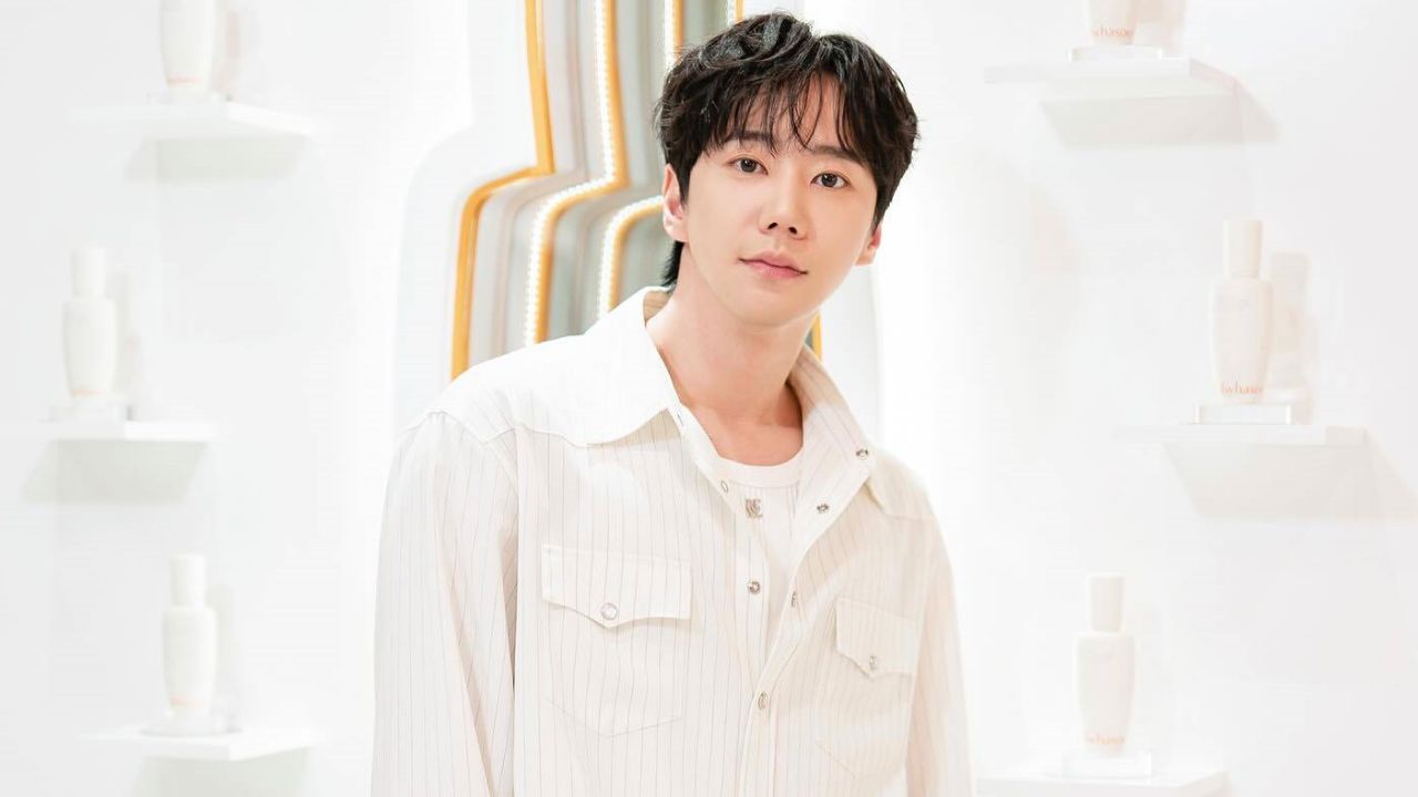 Lee Jun Young embraces effortless quiet luxury in an airy pinstriped overshirt layered over a pristine white top, setting a refined standard for modern smart-casual elegance.