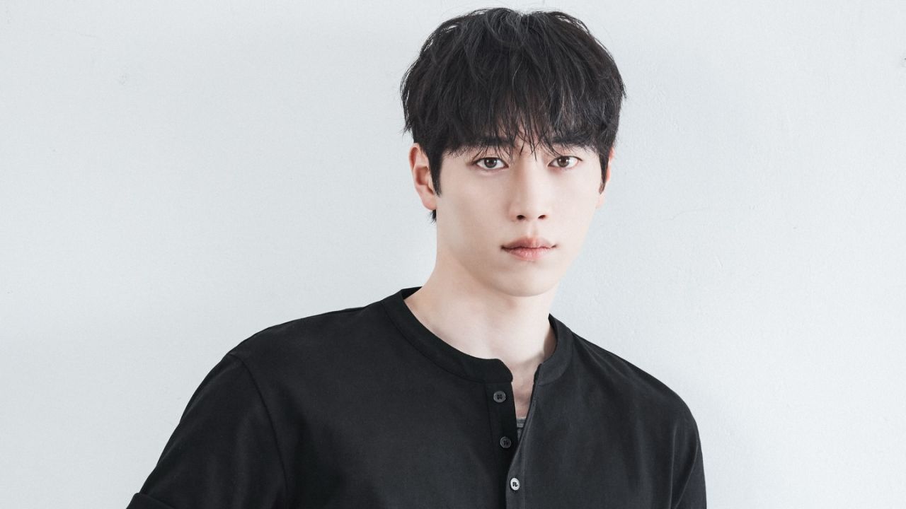Seo Kang Joon effortlessly captures understated elegance in a sleek black button-front henley, demonstrating how minimalist monochrome basics can elevate everyday contemporary style.