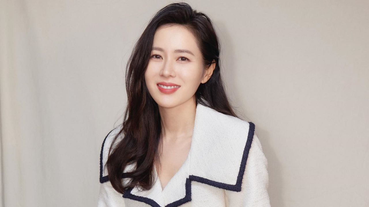 Son Ye Jin exudes timeless sophistication in an ivory structured tweed jacket accented with contrasting dark trim, effortlessly embodying the essence of modern quiet luxury.